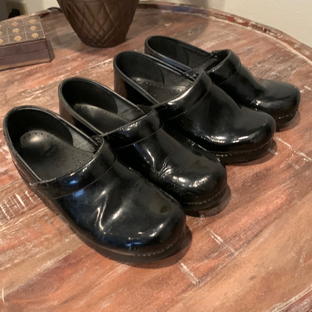 Two pairs of black Dansko clogs leather uppers